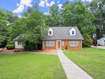 Charming brick home with a well-manicured lawn and lovely landscaping providing great curb appeal at 2458 Zachary Woods Dr, Marietta, GA 30064
