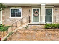 Charming brick townhouse with wreaths adorning the front doors and a lovely front entrance at 6900 Roswell Rd # 3N, Atlanta, GA 30328