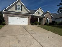 Charming one-story home with a two-car garage, brick accents, and a well-maintained lawn at 21 Spring Folly Nw, Cartersville, GA 30121