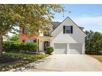 Charming two-story home featuring a manicured lawn and two-car garage at 40 Wimberly Way, Covington, GA 30016