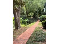 Charming brick pathway leading to a bridge with lush greenery surrounding the property at 260 Manning Sw Rd # 42, Marietta, GA 30064