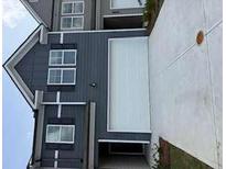 Home exterior with a light grey and dark grey siding, and a white garage door at 1122 Edinberg Dr, Villa Rica, GA 30180