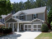 Charming two-story home with a well-manicured lawn, two-car garage, and attractive architectural details at 1535 Justine Se Way, Mableton, GA 30126