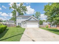 Charming two-story home with a well-manicured lawn, driveway, and an attached two-car garage at 2055 Summer View Place Sw, Marietta, GA 30060