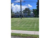 Charming ranch home featuring a lush, well-manicured lawn and inviting curb appeal at 4925 Happy Hollow Rd, Dunwoody, GA 30360