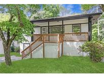Charming home featuring a brick facade, inviting porch, and well-maintained lawn at 644 Church Nw St, Atlanta, GA 30318