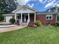 Charming brick home featuring a well-manicured lawn and inviting front porch at 126 Brittany Dr, Canton, GA 30115