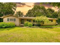 Charming ranch home with a spacious front yard and mature trees, creating a serene and inviting curb appeal at 2368 Ellis Court, Snellville, GA 30078