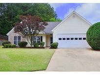 Charming single-story home boasts a well-manicured lawn, stone accents, and an attached two-car garage at 282 Ellesmere Court, Buford, GA 30518