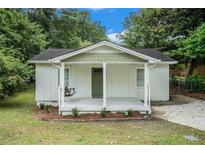 Charming cottage-style home features a cozy front porch with a swing, perfect for relaxing outdoors at 376 Pine Ne St, Marietta, GA 30060