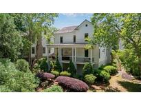 Beautiful two-story home with a covered front porch and lush landscaping at 6715 Pond Rd, Cumming, GA 30040