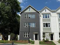 New three-story townhome featuring a stylish black brick facade and large windows for ample natural light at 101 Mission Se Way # 101, Atlanta, GA 30315