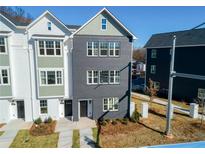 Beautiful new construction townhome with dark painted brick and numerous windows at 101 Mission Se Way # 101, Atlanta, GA 30315