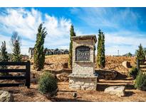 The Enclave at Azalea Hills neighborhood sign with landscaping in front of new construction homes at 235 Ivey Ter, Temple, GA 30179