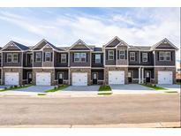 Charming townhomes with two-car garages, dark siding, brick accents, and symmetrical gable roofs at 235 Ivey Ter, Temple, GA 30179
