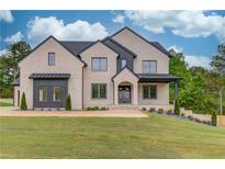 Beautiful two-story home with modern brickwork, a well-manicured lawn, and professional landscaping at 3203 Bold Springs Rd, Dacula, GA 30011