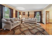 Inviting living room featuring hardwood floors, neutral paint, and comfortable sofas at 2030 Spring End Ct, Lawrenceville, GA 30044