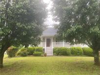 Charming home featuring a well-manicured lawn and inviting front porch at 68 Paradise Pointe, Douglasville, GA 30134