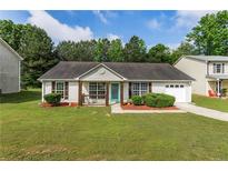 Charming one-story home with well-maintained lawn and inviting front porch at 9263 Club View Trce, Riverdale, GA 30274