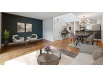 Inviting living room boasts hardwood floors and an open floor plan to the kitchen and dining areas at 346 Carpenter Dr # 77, Sandy Springs, GA 30328