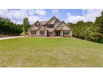 Attractive home featuring well-manicured lawn and traditional architecture at 127 Grayson Myers Dr, Villa Rica, GA 30180