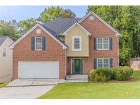 Charming two-story brick home featuring a two-car garage and well-maintained lawn at 3717 Lockerbie Ln, Powder Springs, GA 30127