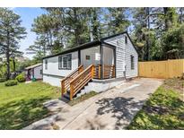 Charming home featuring crisp white siding, black trim, and a well-maintained yard at 4134 Burgess Dr, Decatur, GA 30035