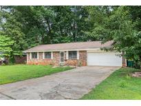 Charming single-story brick home with a well-maintained lawn and attached garage at 2954 Ann Marie Ln, Rex, GA 30273