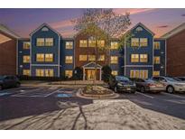 Three-story apartment building in brick and blue with parking in front during daylight at 3302 Dogwood Dr # 328, Atlanta, GA 30354