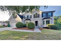 Charming two-story home with dark shutters, landscaped yard and attached two car garage at 2352 Benson Rdg, Lithonia, GA 30058