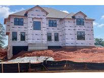 Construction of a new two-story home with architectural details and window installations in a landscaped community at 3066 Reserve Ct Sw, Conyers, GA 30094