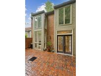 Charming brick patio off the rear of the home with large windows and door, perfect for outdoor entertaining at 68 Willow Ne Gln, Atlanta, GA 30342