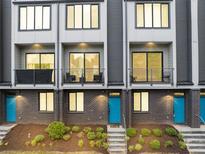 Beautiful townhome featuring brick facade, private balconies, and eye-catching, bright blue doors at 701 Pryor Sw St # 5, Atlanta, GA 30315