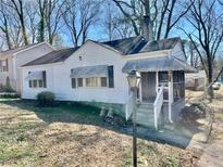 Charming single-Gathering home with a covered porch and mature trees surrounding the property at 1386 Bluefield Sw Dr, Atlanta, GA 30310
