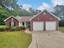 Charming brick home with a well-maintained front yard and a two-car garage at 3146 Leyland Ct, Decatur, GA 30034