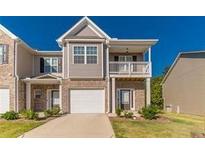 Charming townhome boasts a covered porch and attached garage at 7162 Fringe Flower Dr, Austell, GA 30168
