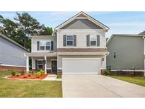 Charming two-story home with a gray exterior, covered porch, and two-car garage at 9007 Jim Purcell Dr, Covington, GA 30014