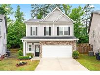 Charming two-story home with stone accents, a two-car garage, and manicured landscaping at 2939 Woodward Down Trl, Buford, GA 30519