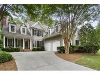 Charming two-story home with a well-manicured front yard and a two-car garage at 4404 Old Georgetown Trl, Atlanta, GA 30338