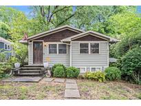 Charming home with a well-maintained lawn and inviting front entrance at 677 Holmes Nw St, Atlanta, GA 30318