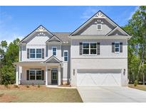 Beautiful two-story home boasts a brick and siding exterior, attached two-car garage, and well-manicured front yard at 2749 Porches Ln, Dacula, GA 30019