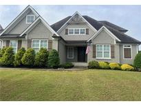 Charming home with a well-manicured lawn and a mix of brick and siding exterior at 312 Archway Ln, Peachtree City, GA 30269