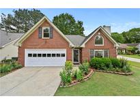 Charming brick home with a well-manicured lawn and an attached two-car garage at 4730 Fairway View Ct, Duluth, GA 30096