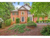 Charming two-story brick home with a well-manicured lawn and mature landscaping in a tranquil setting at 946 Cornwall Sw Ct, Marietta, GA 30064