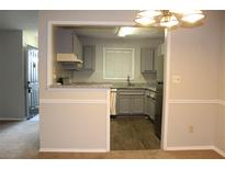Bright kitchen features stainless appliances, granite countertops, and hardwood floors at 1105 Natchez Trce, Atlanta, GA 30350