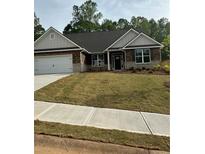 Charming brick home with a well-manicured front yard and attached two-car garage at 3006 Fairway Dr, Villa Rica, GA 30180