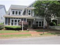 Charming two-story home with a well-maintained front yard, inviting entrance and mature trees at 1527 Princeton Ave, College Park, GA 30337