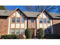 Charming two-story brick townhome featuring Tudor-style accents and well-manicured landscaping at 2825 Northeast Ne Expy # F3, Atlanta, GA 30345