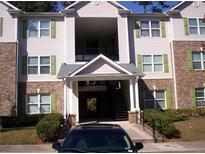 A three story apartment building with brick accents, green shutters, and manicured shrubbery at 3201 Fairington Dr, Lithonia, GA 30038
