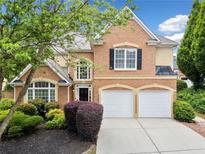 Charming brick home features a two-car garage and well-manicured landscaping at 604 Bassett Se Ct, Smyrna, GA 30080